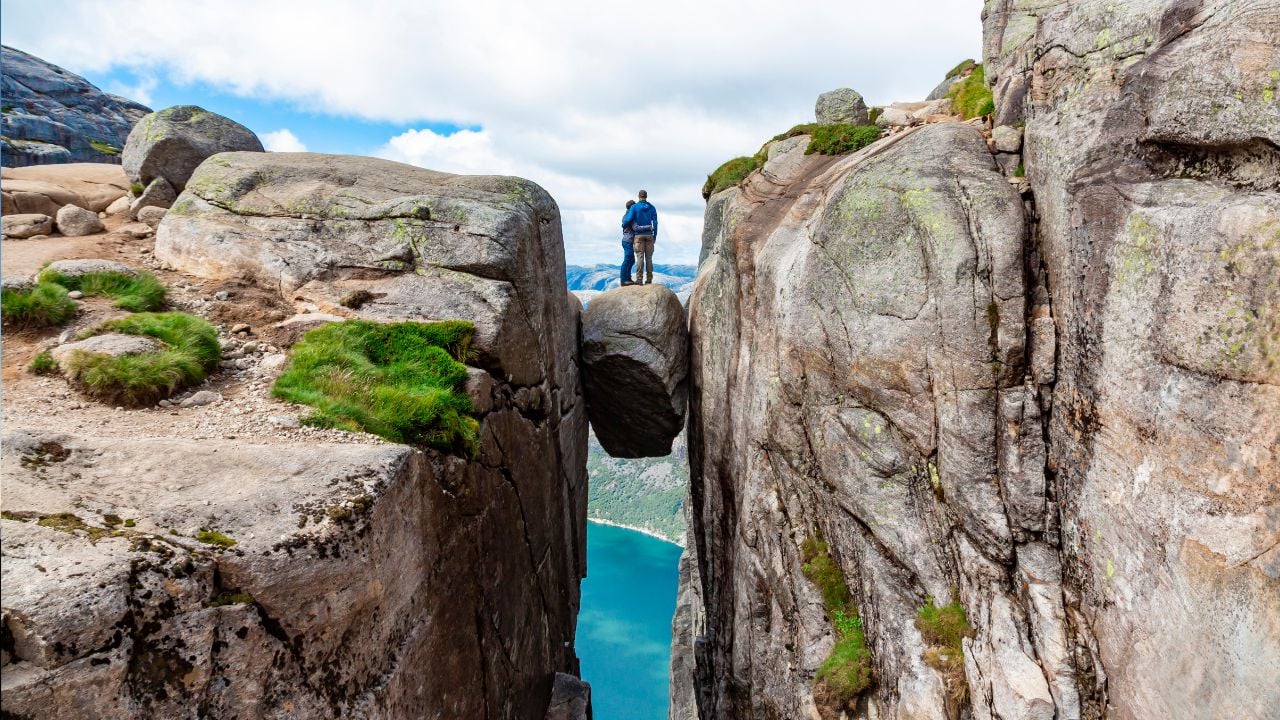 successful couple and spectacular views on risky rocks