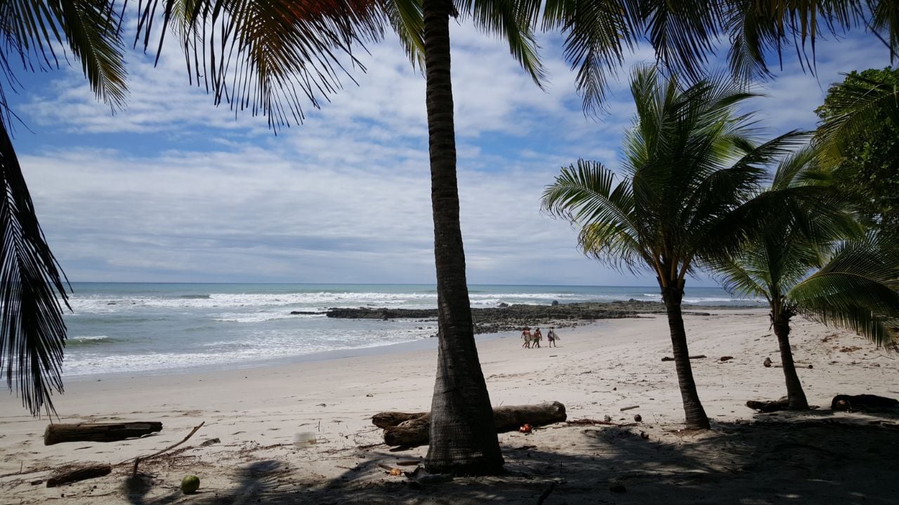 Surfer walking at Playa Santa Teresa in Costa Rica