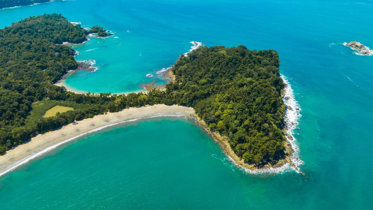 Aerial view of Manuel Antonio National Park in Costa Rica. The best Tourist Attraction and Nature Reserve with lots of Wildlife, Tropical Plants and paradisiacal Beaches on the Pacific Coast.
