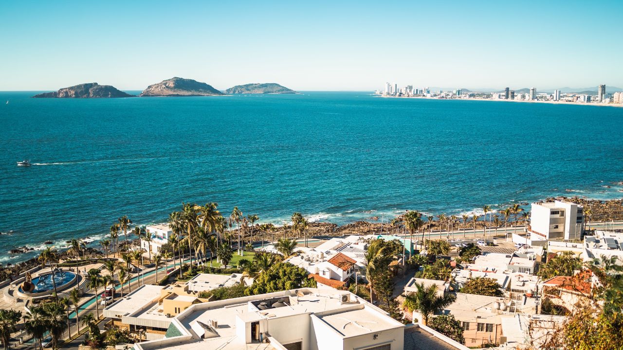 An aerial shot of a sea and buildings in Mazatlan with modern coastal buildings, Mexico
