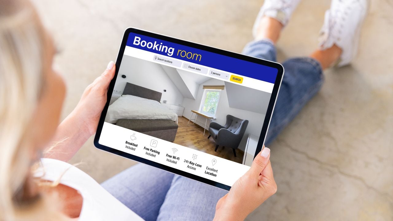 Woman booking room and searching for hotel online