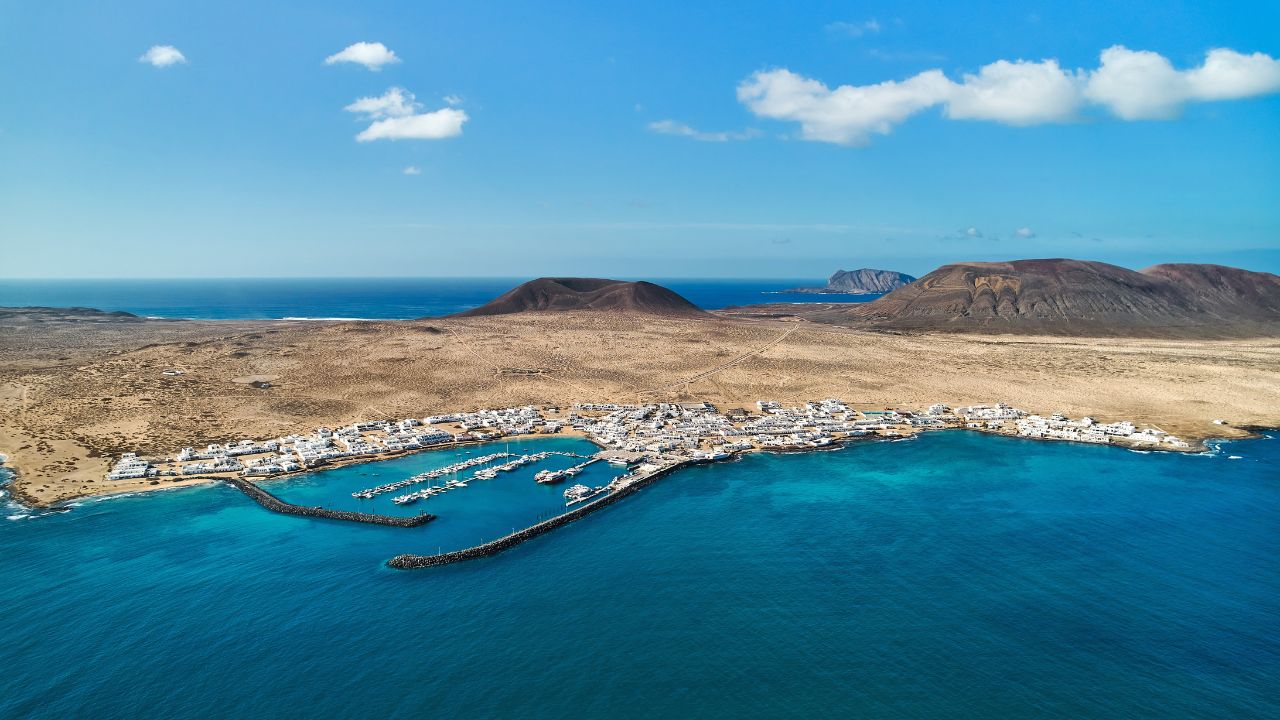 Panoramic view, aerial shot of La Graciosa, volcanic island surrounded by the Atlantic Ocean, photo taken from Lanzarote Island, Canary Islands of Spain. Travel destinations and tourism concept