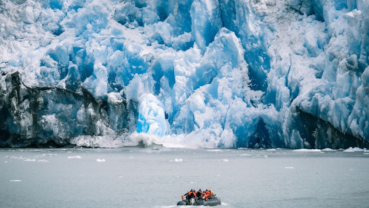 A small boat in front of glaciers in Alaska's Inside Passage