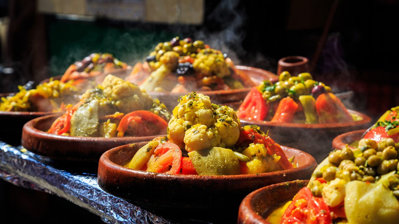 A lot of warm tagines with delicious vegetables on a market in Morocco