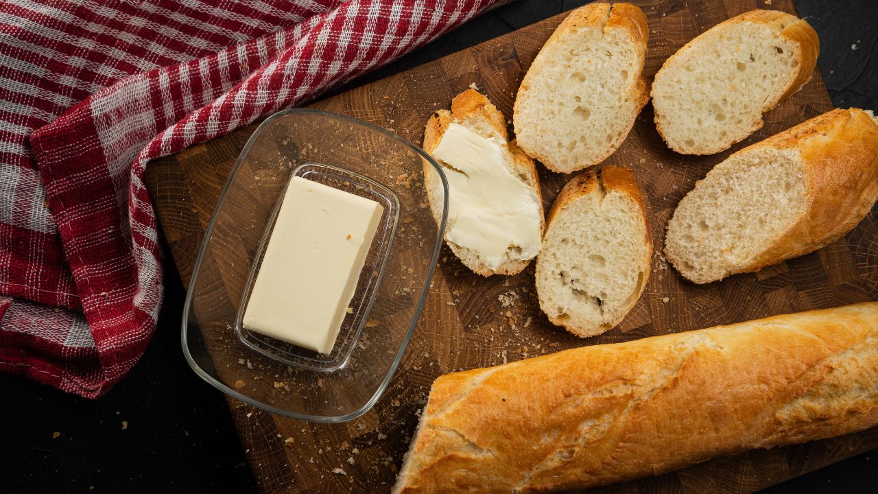 Butter baguette. Dark baking background