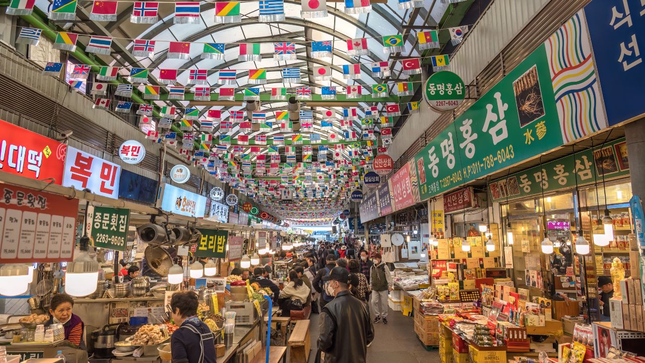 Seoul, South Korea - November 11, 2022 : shop and street food stall with many tourist at Gwangjang Market