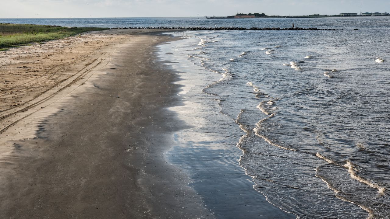 At Grand Isle, Louisiana, the channel entrance to Caminada and Barataria Bays with the ruins of Fort Livingston on Grande Terre Island in the background.