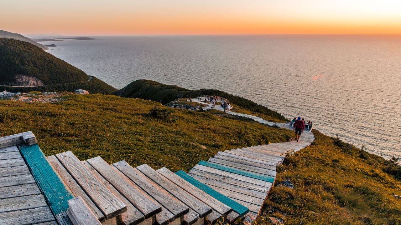 Hiking the scenic Skyline Trail at sunset, Cabot Trail at Cape Breton Highlands National Park, Nova Scotia, Canada. Boardwalk with wooden steps at headland