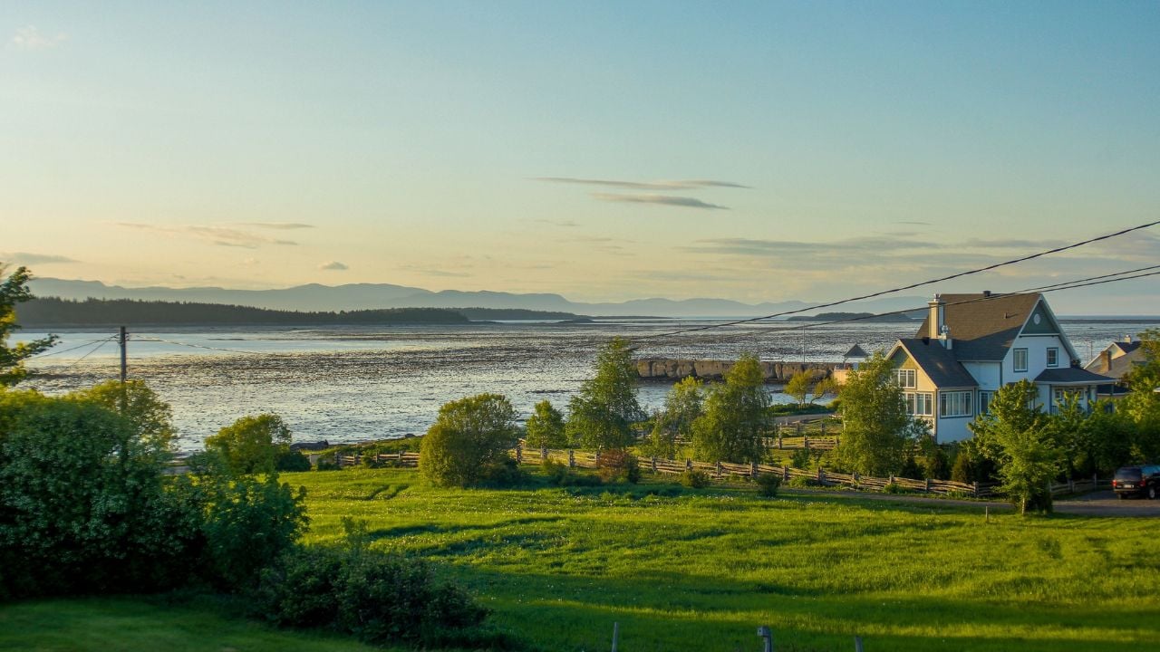 HDR scenic view of sunset in a village by the river low tide Kamouraska in Quebec, Canada