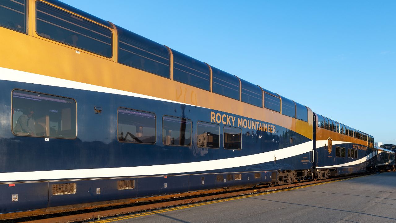 VANCOUVER, CANADA - JULY 22, 2022: Gold leaf Rocky Mountaineer train wagon at sunrise in Vancouver station.