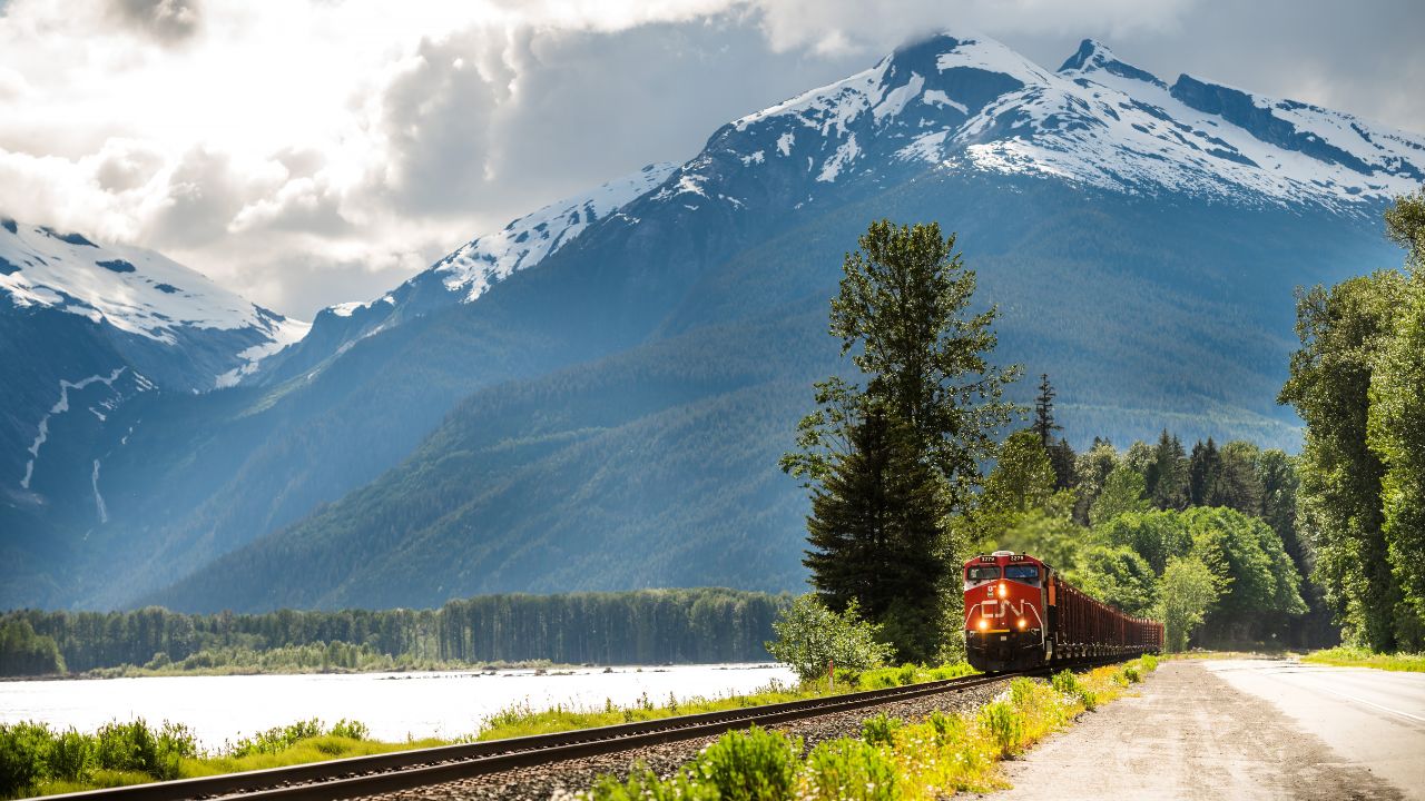 Skeena River, BC, Canada - June 23rd, 2024: CN freight train travels alongside the Skeena River on Highway 16 between Prince George and Prince Rupert BC, Canada.