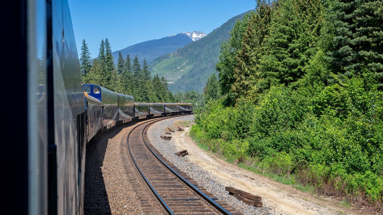 Rocky Mountaineer luxury train rounding bend in the Rocky Mountains, British Columbia, Canada on 3 June 2023