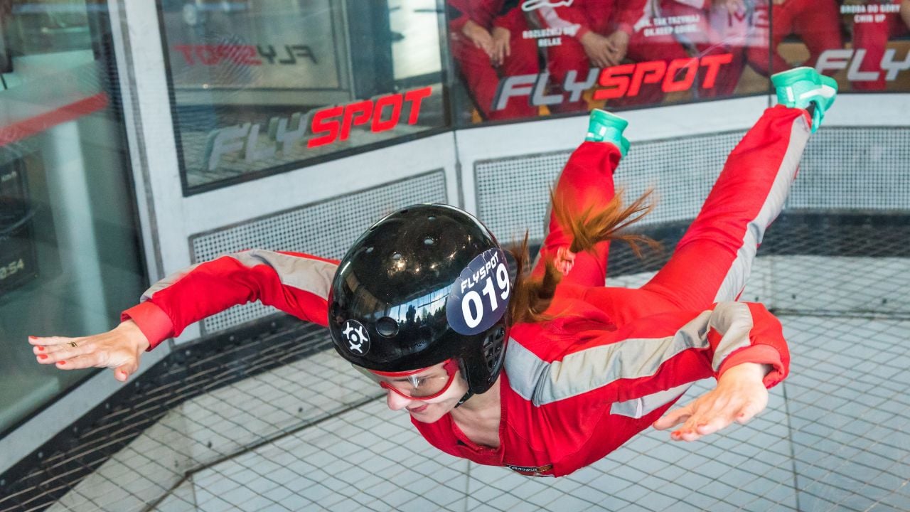 WARSAW, POLAND, AUGUST 5, 2017: Young woman flying in an aerodynamic tunnel.