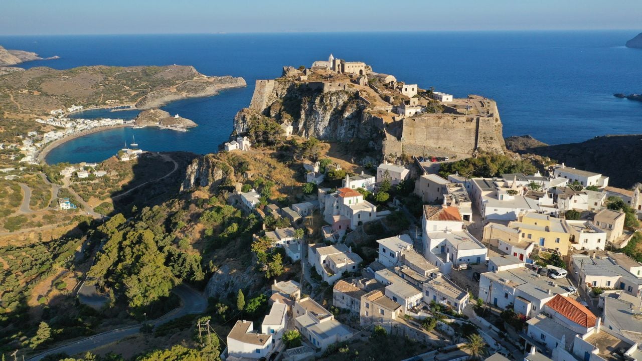 Aerial drone photo of iconic medieval castle of main village of Kithira island overlooking beautiful double bay and beach of Kapsali at sunset, Kythira island, Ionian, Greece