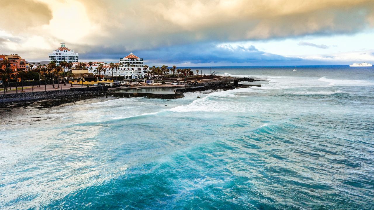 tenerife las americas vacation beautiful place. tropical iscland aerial view of ocean and waves and beach. nice colours and background. horizon and clouds in the morning