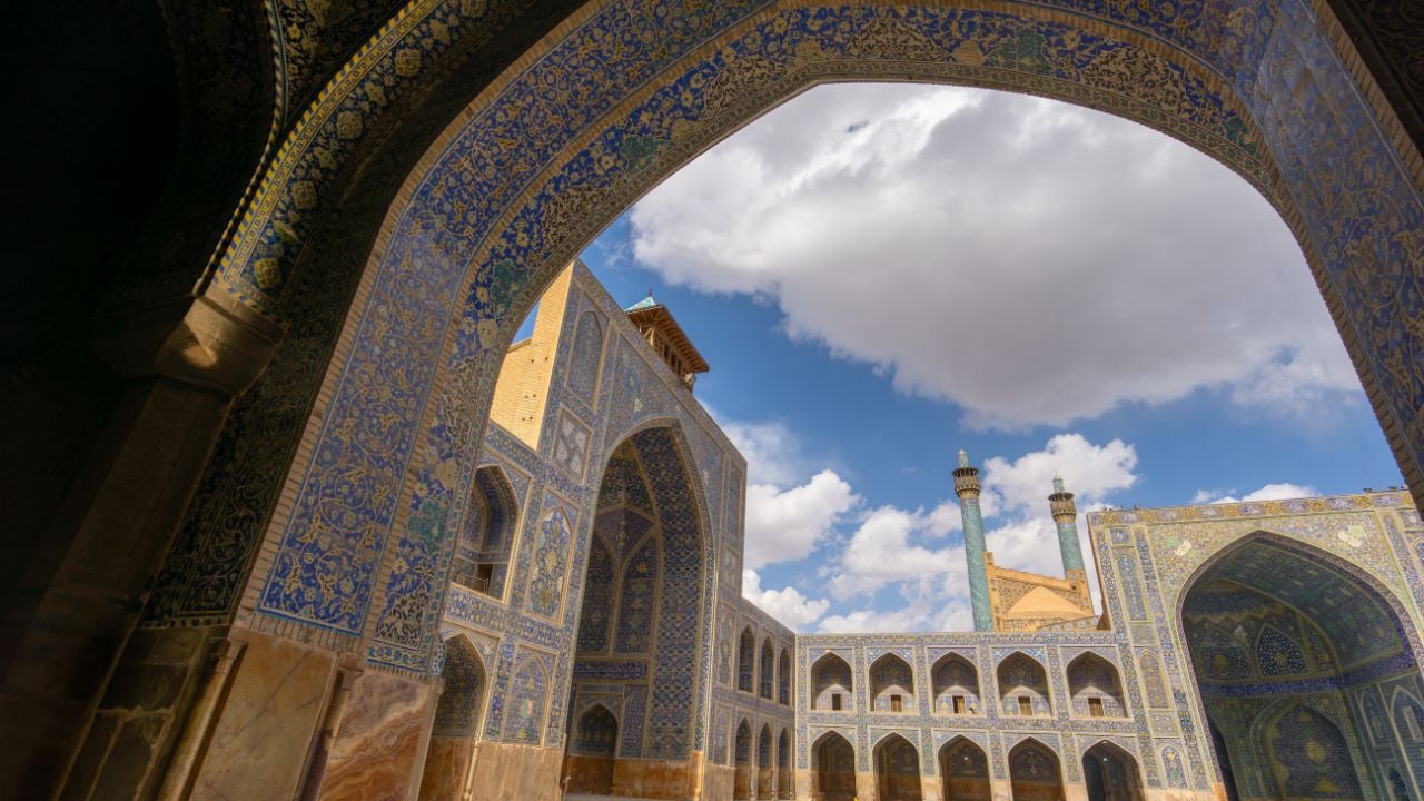 Stunning Persian-Islamic architecture with minarets and intricate tiles in vibrant blue tones. Imam Mosque, Naqsh-e Jahan Square, Isfahan, Iran.