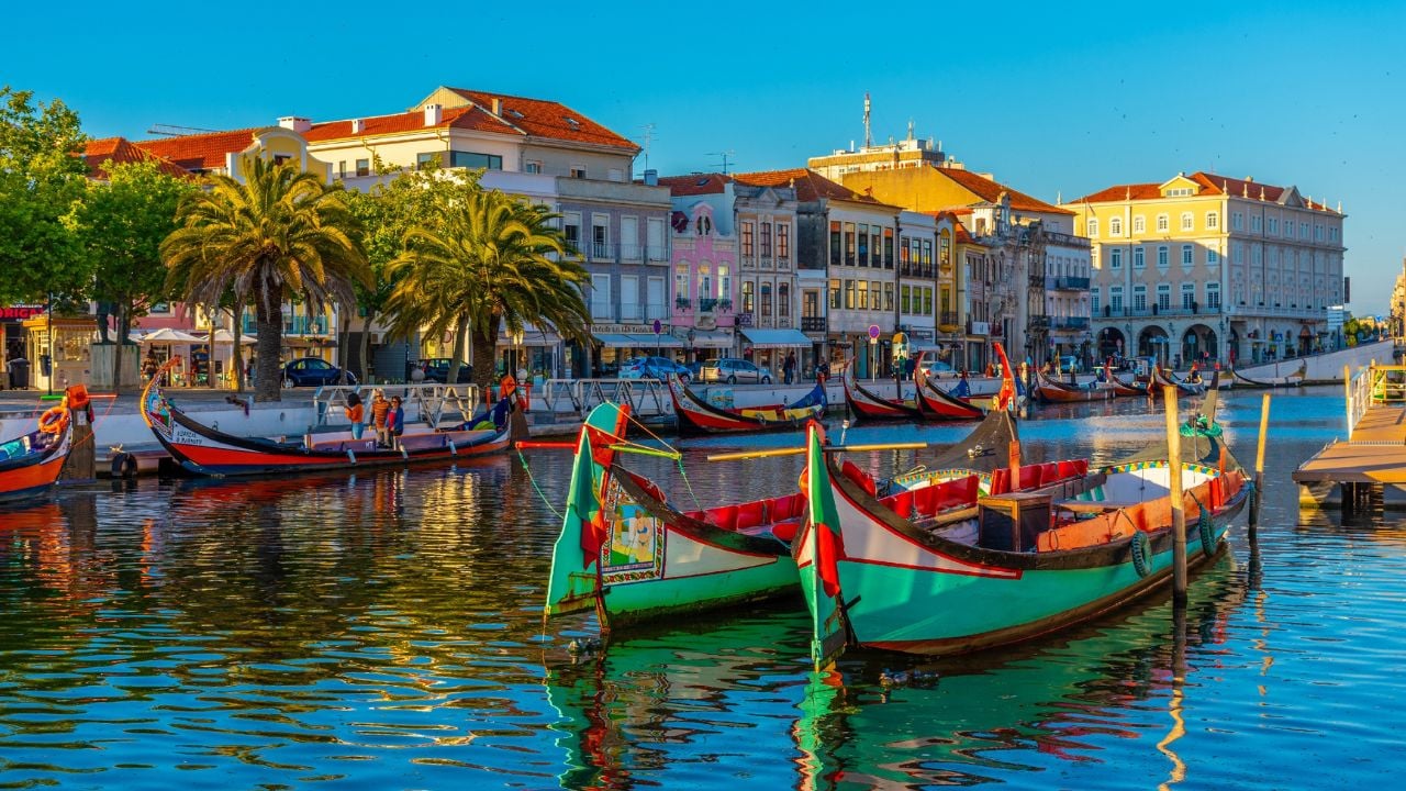 AVEIRO, PORTUGAL, MAY 21, 2019: Moliceiro boats mooring alongside the central channel at Aveiro, Portugal