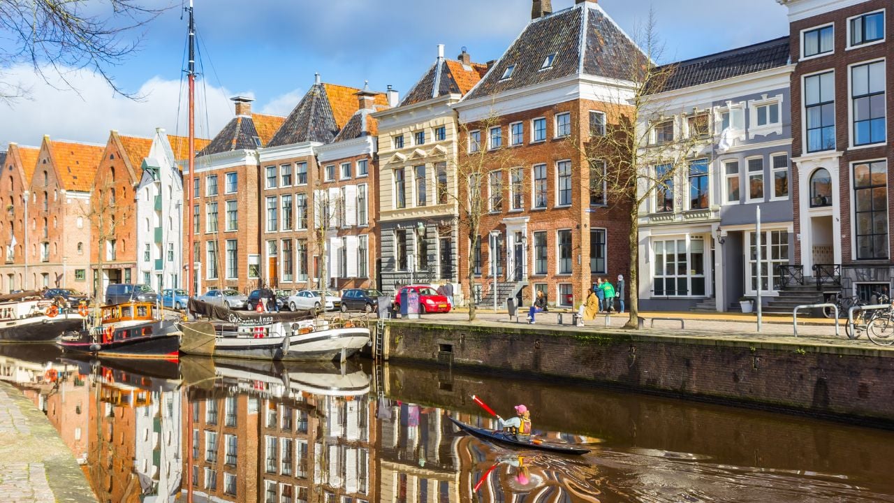 GRONINGEN, NETHERLANDS - FEBRUARY 17, 2024: Canoe going through the historic Hoge Der Aa canal in Groningen, Netherlands