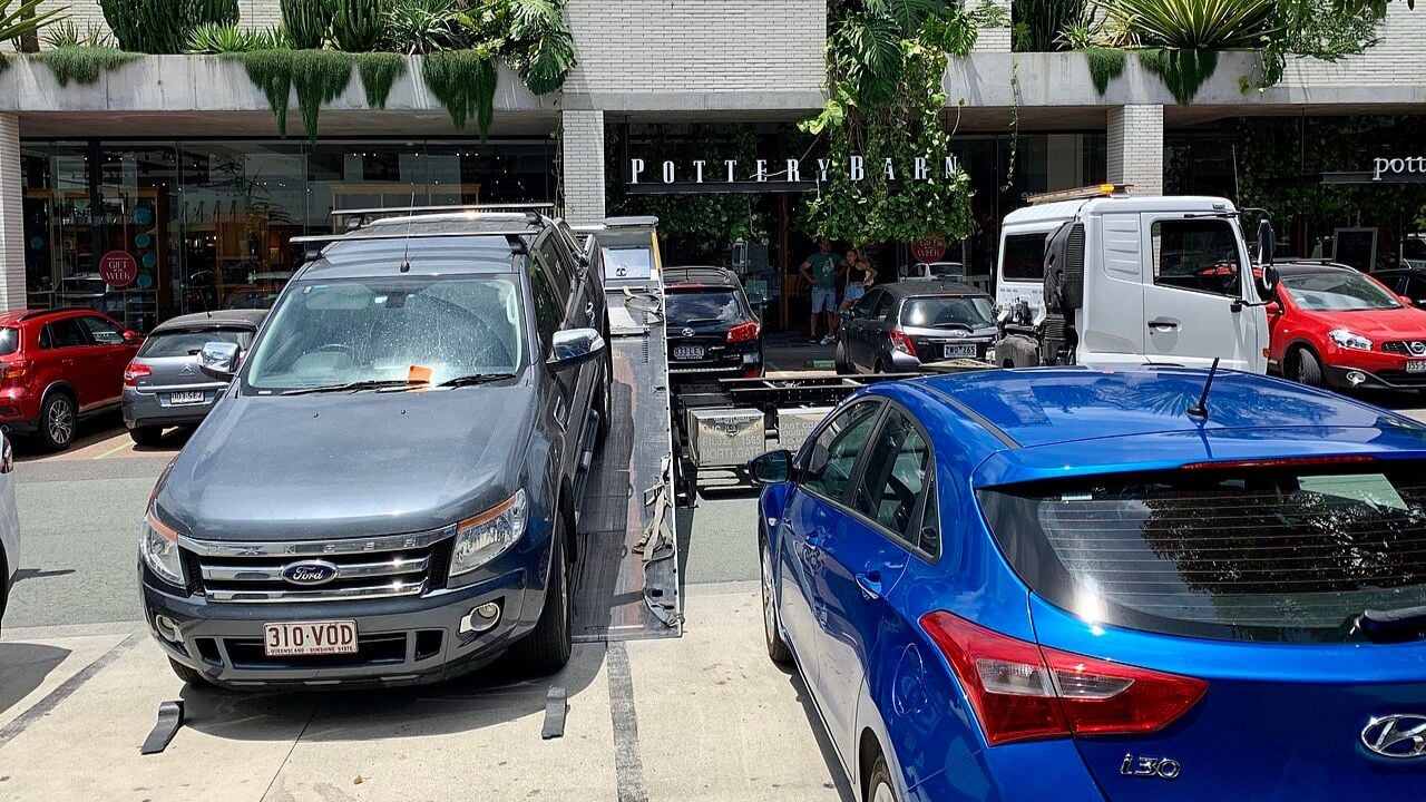 Car being towed away from a carpark in Brisbane.