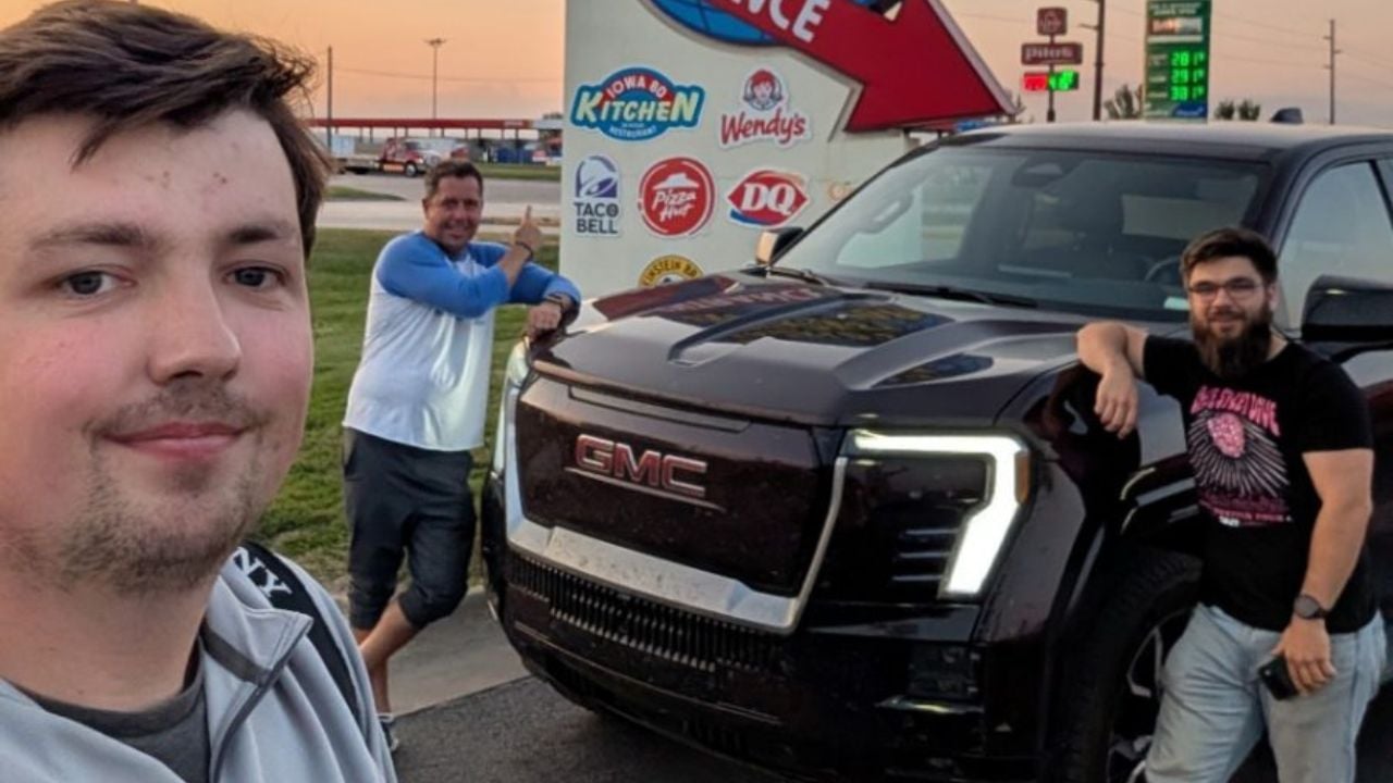 GM engineers pose with the GMC Sierra pickup truck.