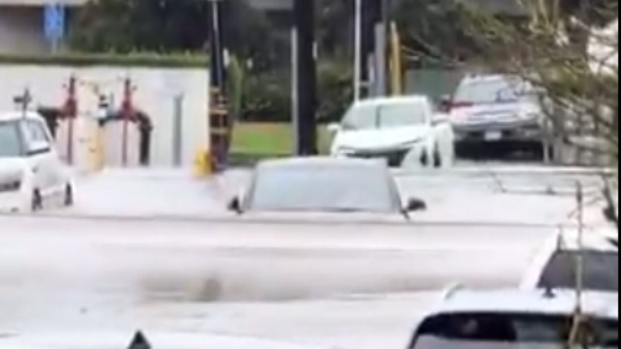 Tesla wades through flooded street in California.
