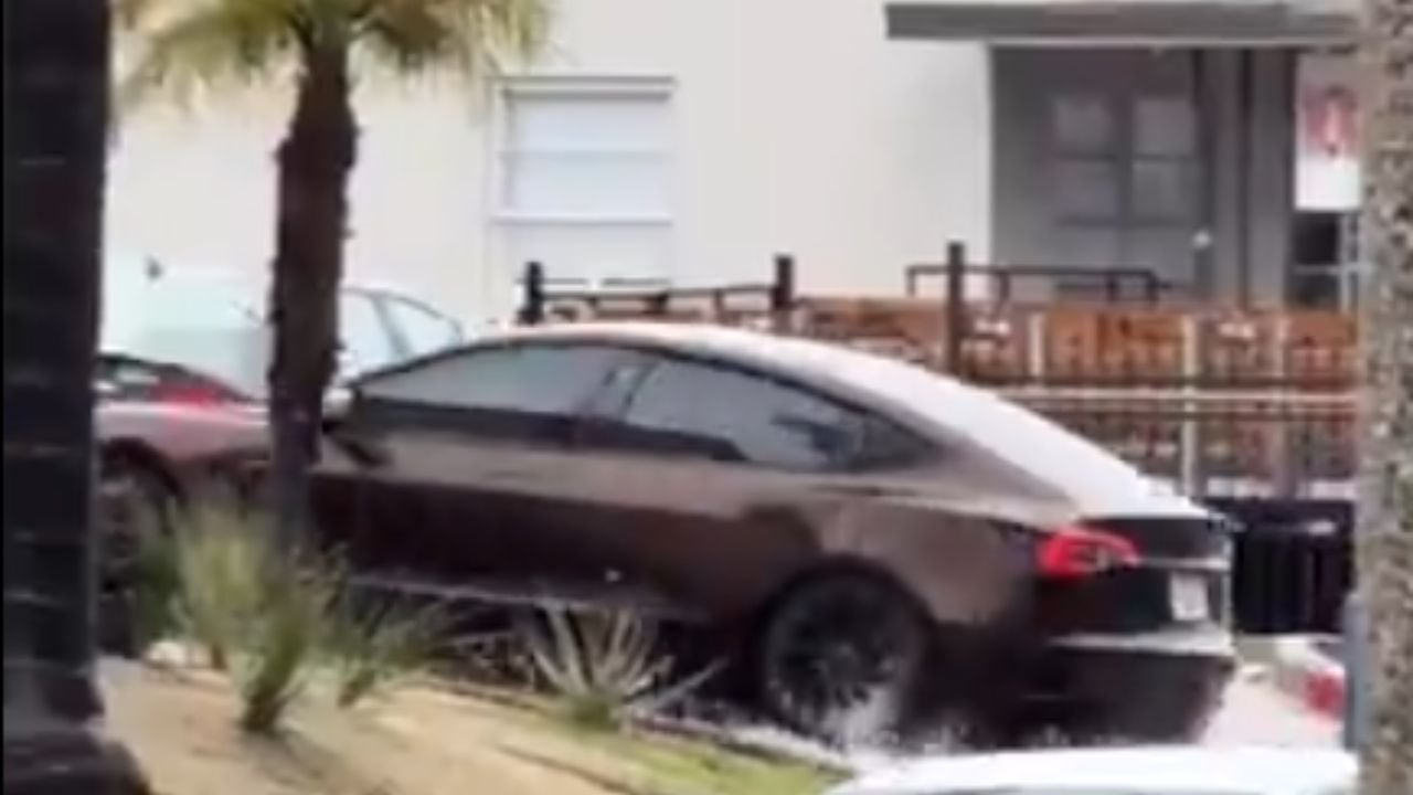 Tesla wades through flooded street in California.