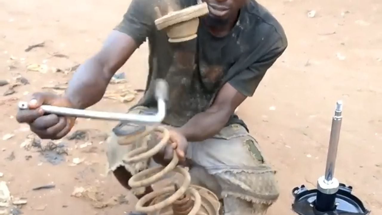 Mechanic working on a Lexus RX shock absorber.