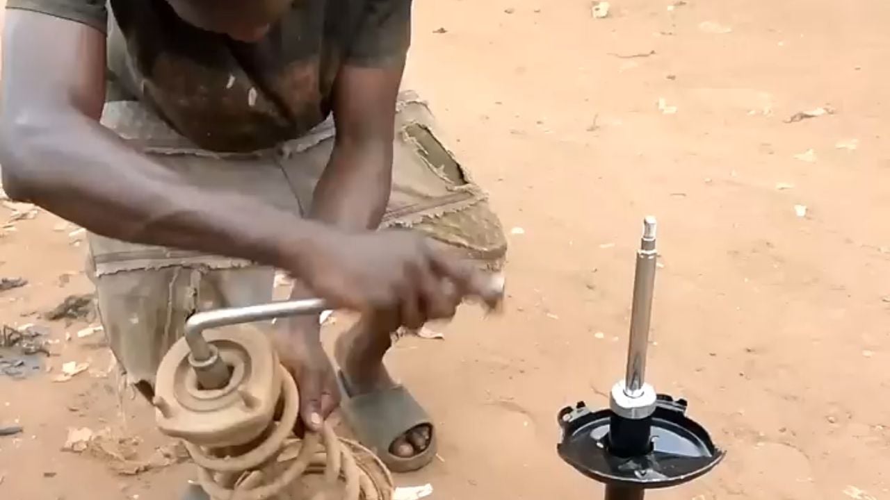 Mechanic working on a Lexus RX shock absorber.