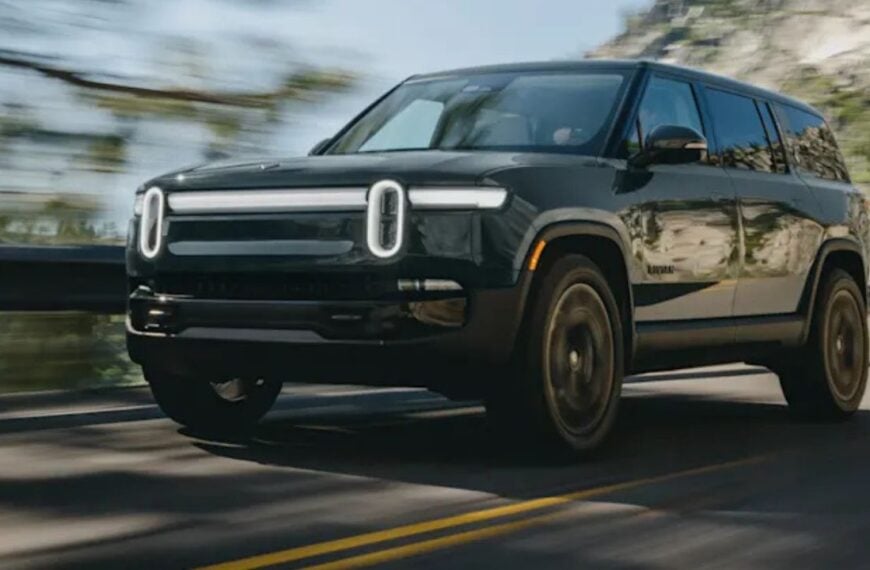 Black 2026 Rivian R1S Quad-Motor front 3/4 view driving