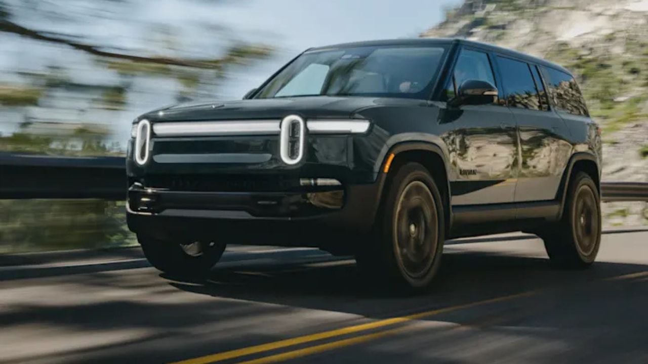 Black 2026 Rivian R1S Quad-Motor front 3/4 view driving