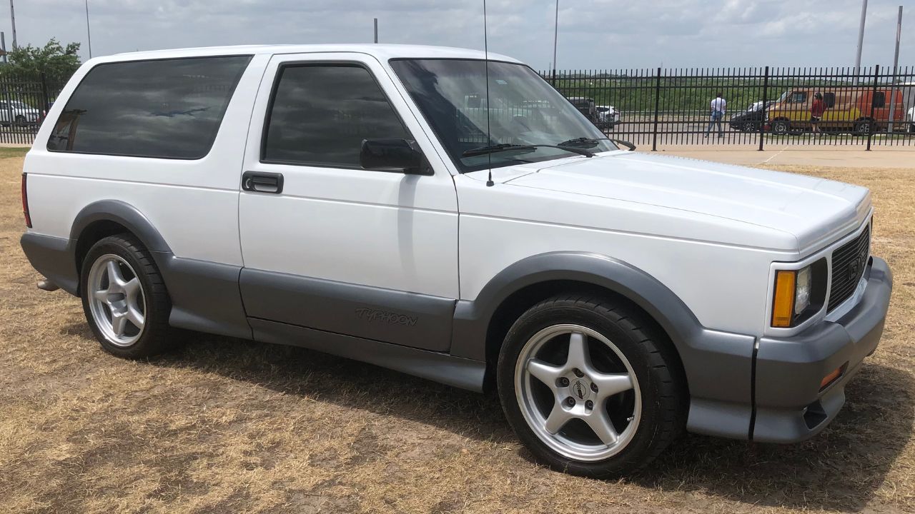 White GMC Typhoon with gray bumpers and side skirts Front 3/4 view parked