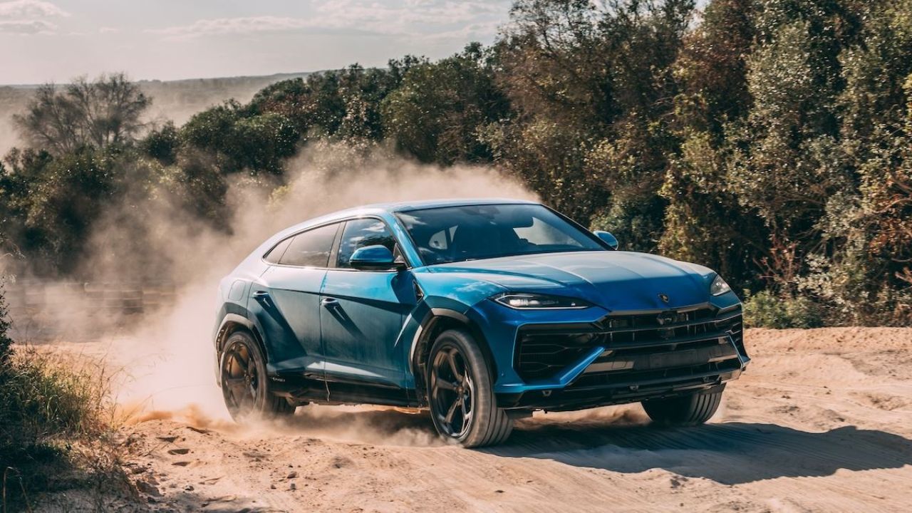Blue 2026 Lamborghini Urus SE front 3/4 offroad driving