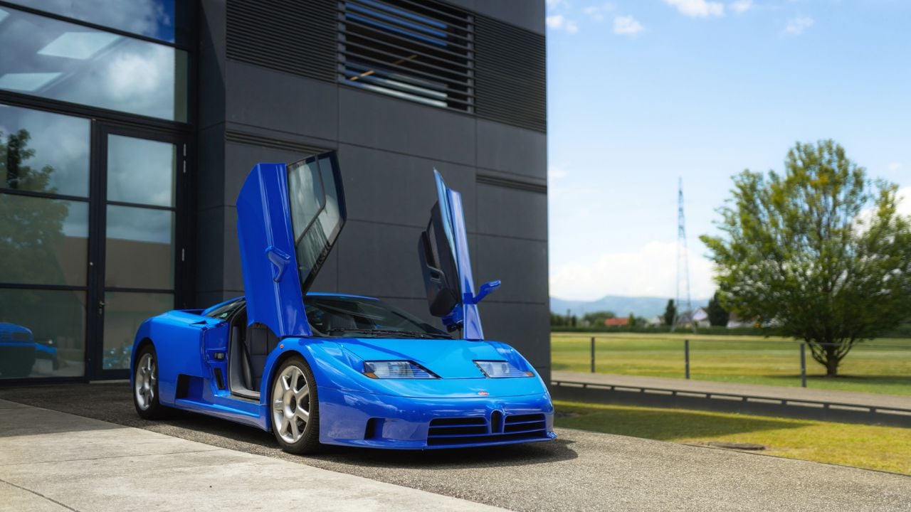 Blue Bugatti EB 110 front 3/4 parked with scissor doors open