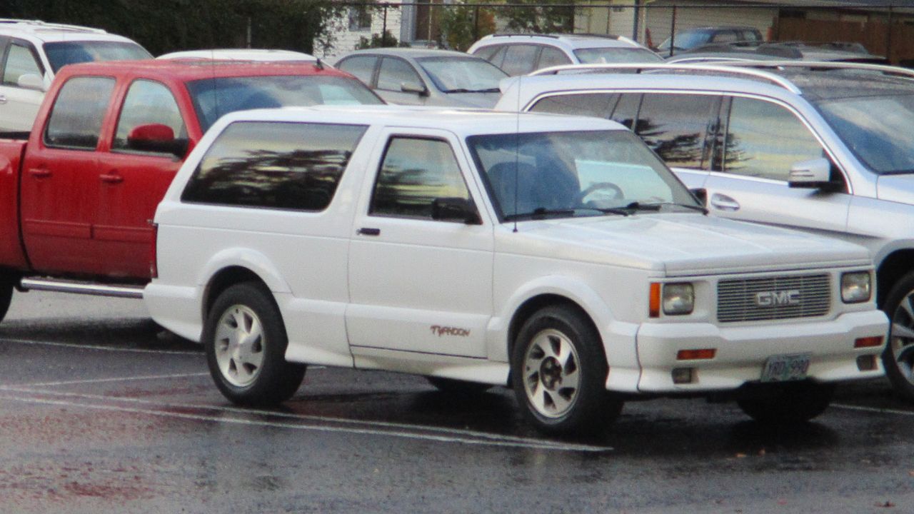 White GMC Typhoon front 3/4 view in a parking lot