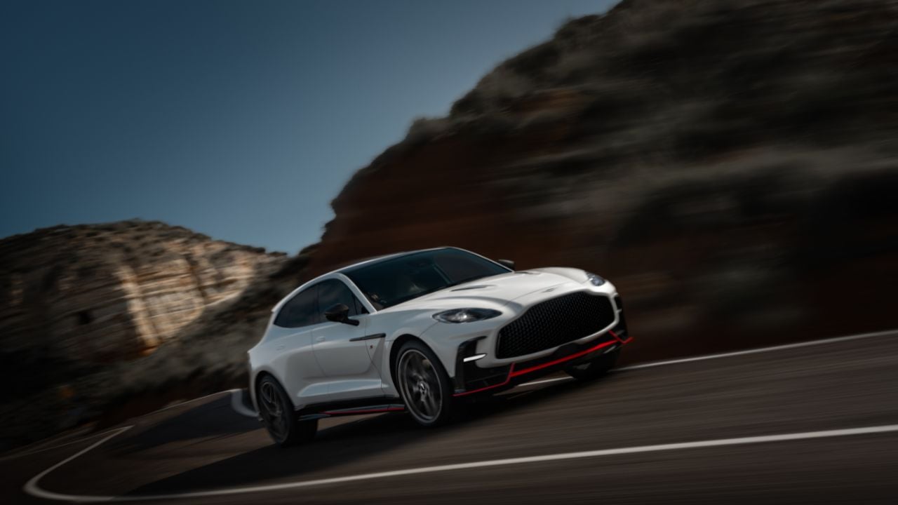 White 2026 Aston Martin DBX S front 3/4 shot driving on a road