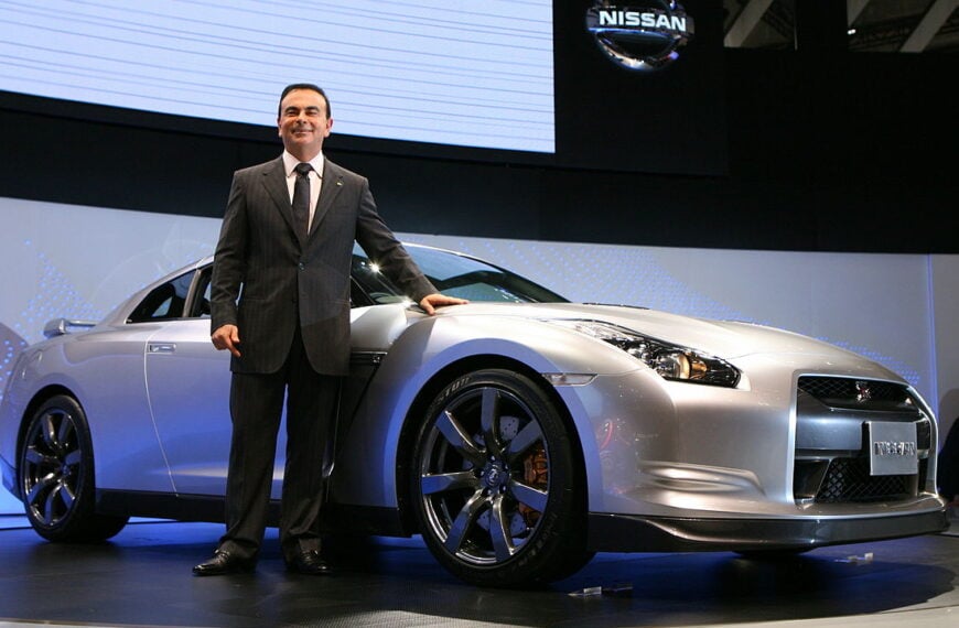 Carlos Ghosn poses with the Nissan GT-R.