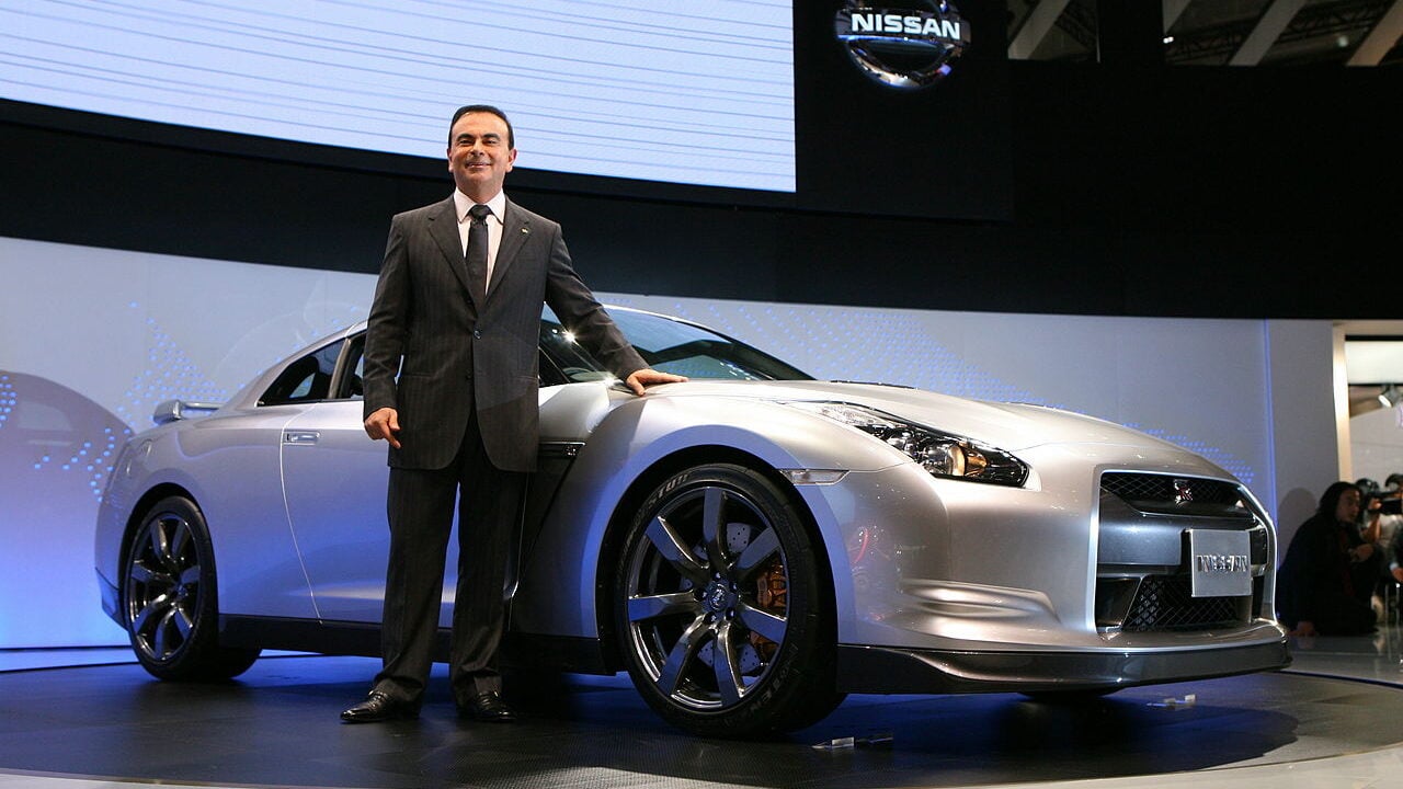 Carlos Ghosn poses with the Nissan GT-R.
