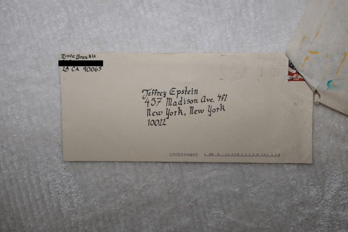 Envelope addressed to Jeffrey Epstein in New York with a handwritten recipients name and address on a light-colored background.