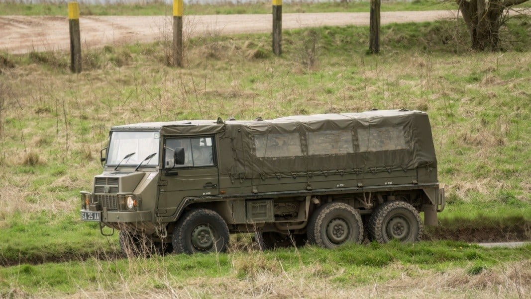 A British army Steyr-Daimler-Puch - BAE Systems Pinzgauer high-mobility 6x6 6WD 6-wheel drive all-terrain utility vehicle in action on a military exercise