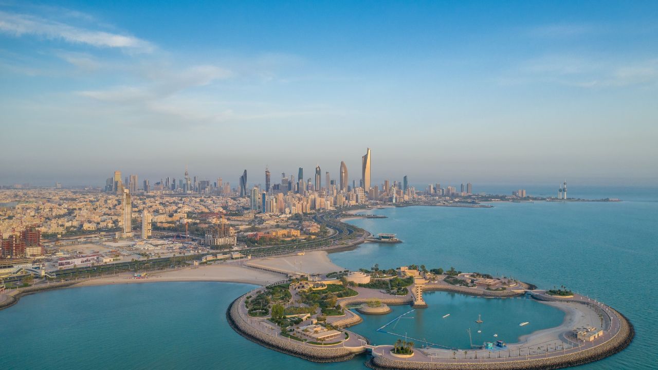 A high-angle shot of The Green Island with a skyline of the city of Kuwait in the background