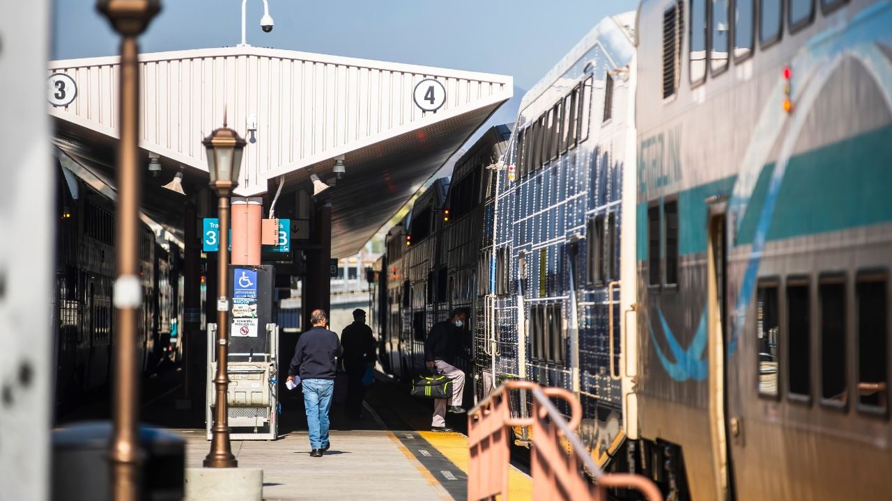 2024-11-20 Los Angeles USAPassengers boarding and walking along Metrolink platforms at a Los Angeles train station under covered structures.