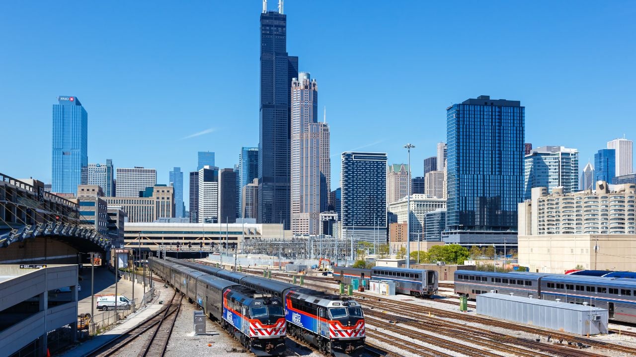 Chicago, United States - May 3, 2023: Skyline with METRA commuter rail trains public transport near Union Station in Chicago, United States.