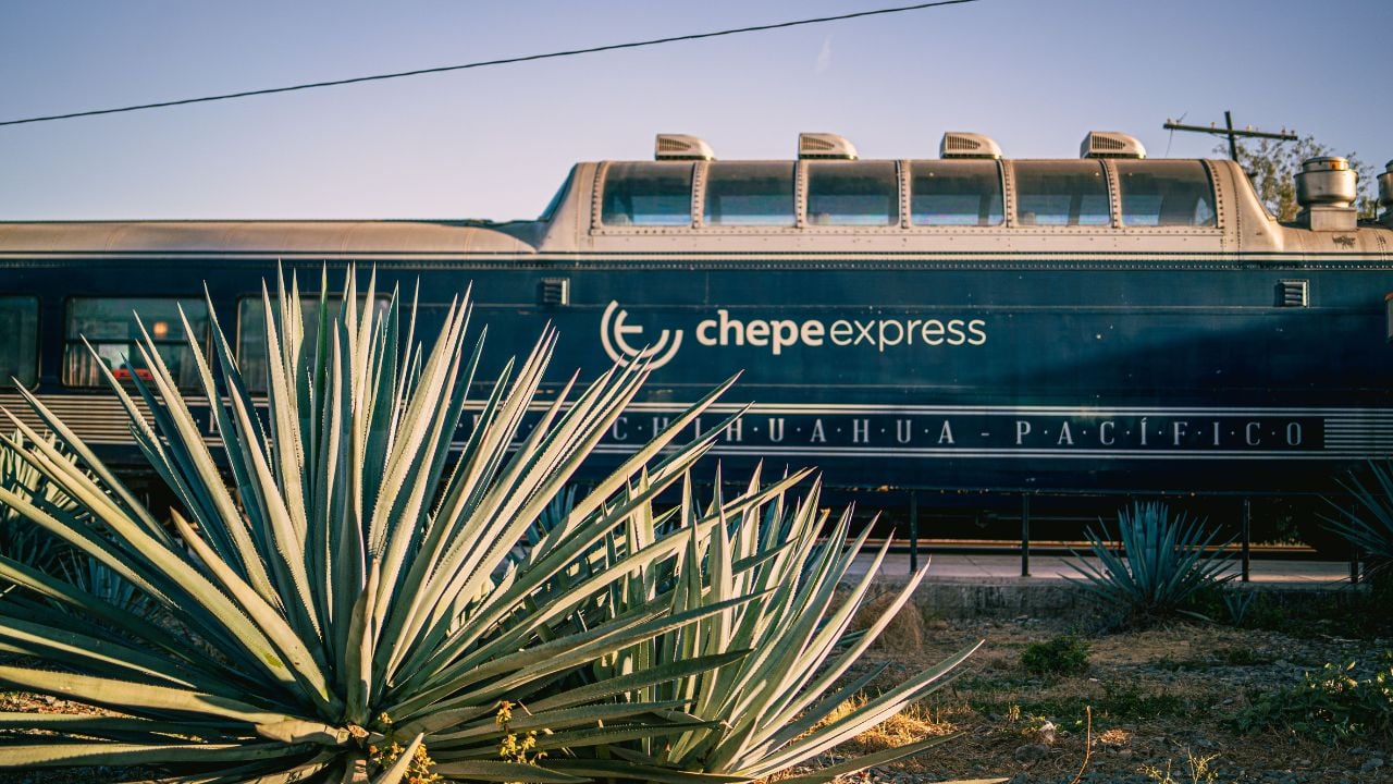 CREEL, MX - Jan 03, 2023: The Chepe Express Train on the railway of Mexico against the sunny blue sky