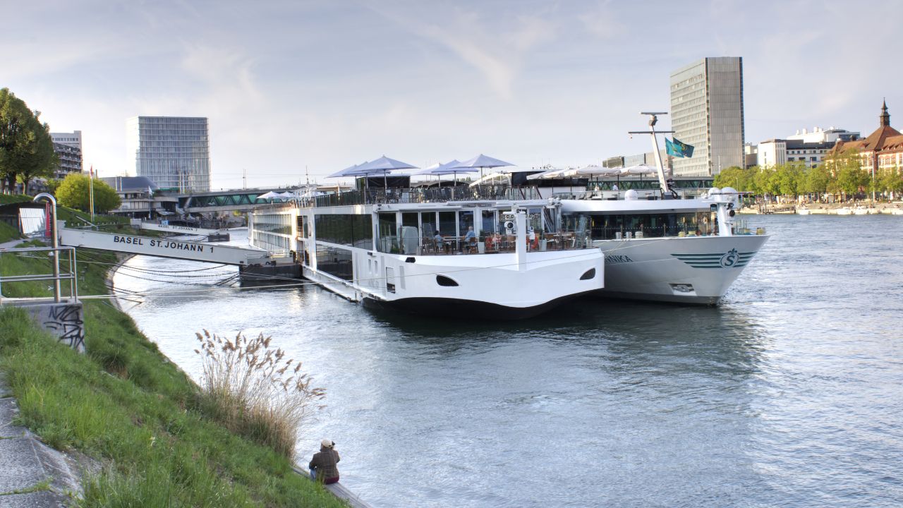 BASEL, SWITZERLAND -April 15, 2022: River cruises docked on the Rhine River at St.Johann port in Basel Stadt. Basel to Amsterdam cruise ship tours. Tourism during vacation.