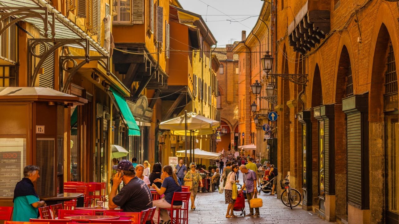 BOLOGNA, ITALY - AUGUST 27, 2016: tourists and locals go shopping in medieval market. The trade vocation of this area known as Quadrilatero, meaning The Quadrilateral Area, was born in Middle Age