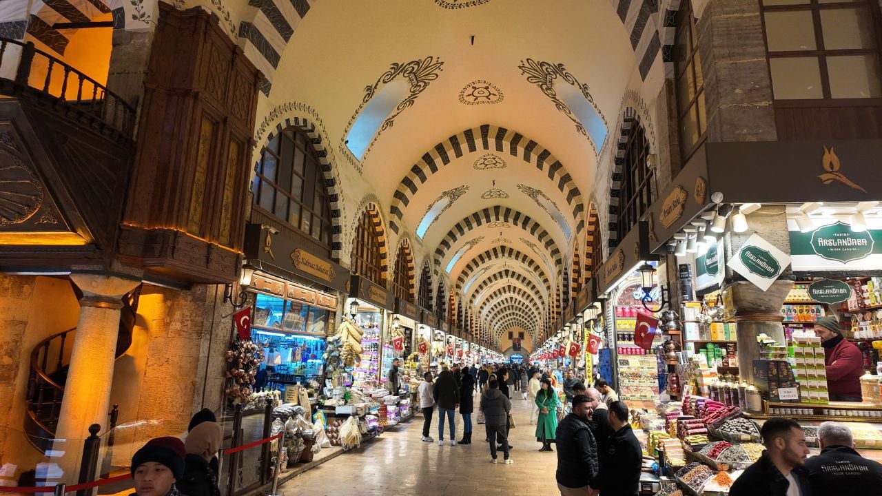 Istanbul, Turkey - August 25, 2025: Tourists walking through the historic Grand Bazaar filled with shops selling spices, sweets, and souvenirs