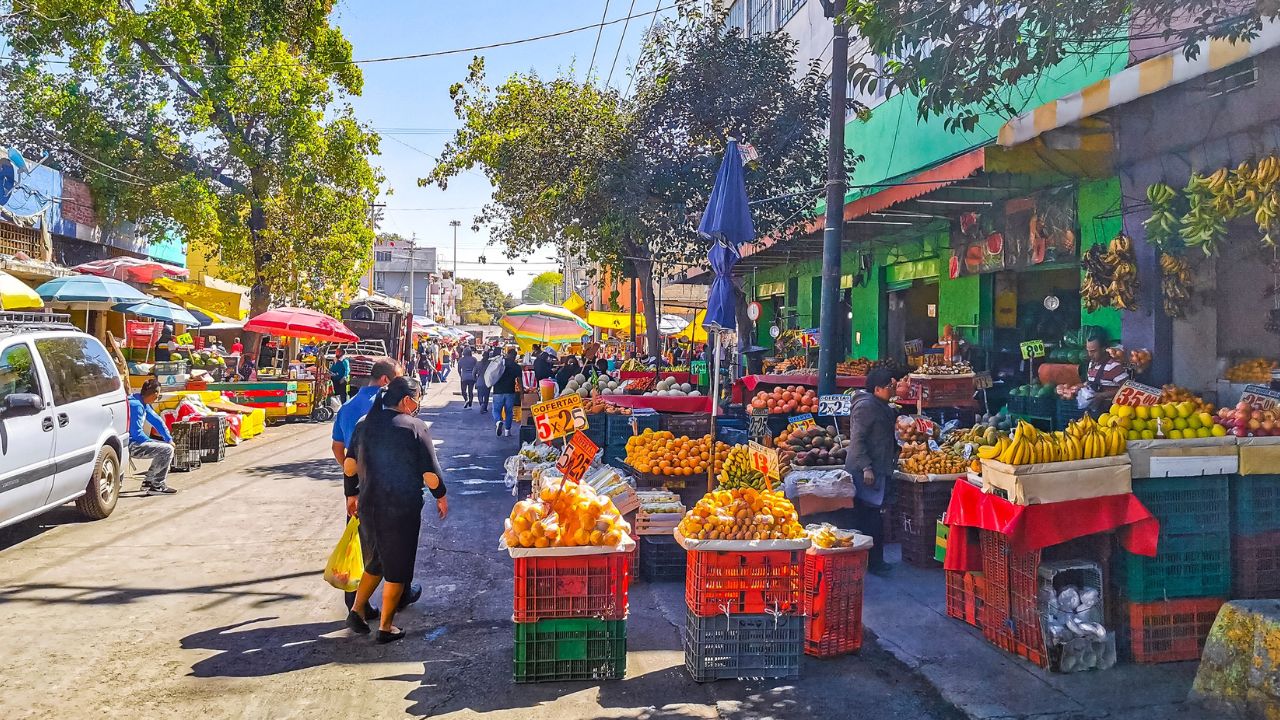 Centro Historico Mexico City Mexico 13. February 2021 Street with market sales stands stores shops and people in Centro Historico Mexico City Mexico.