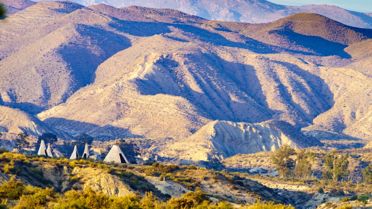Tabernas desert landscape and Red Indian village with wigwams at Western Leone town, Almeria, Spain. Movie location set for spaghetti western.
