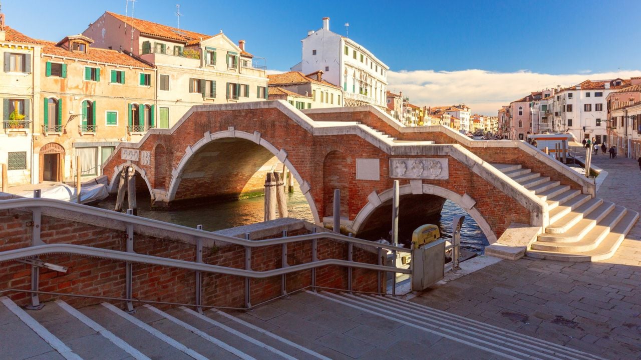 The historic Bridge of Three Arches spanning a canal in the Cannaregio district of Venice, Italy