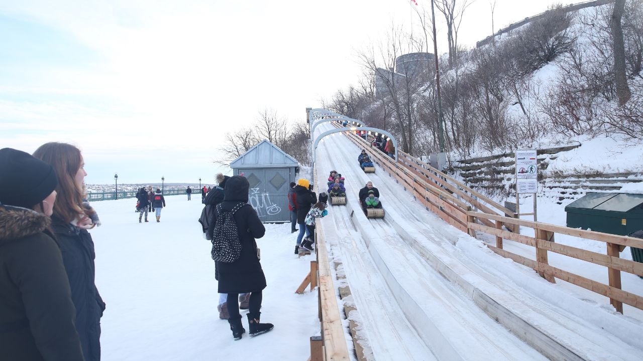 Quebec, Canada-16.12.2018: sledding from the mountain in snowy winter. Winter sport in the city. Christmas Holidays.